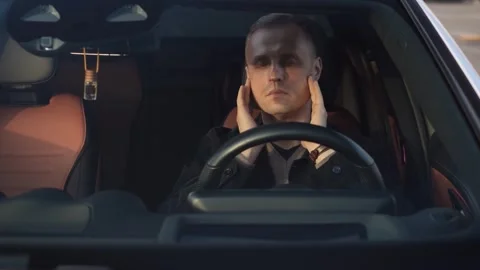 A tired driver massages his temples with his eyes closed Video stock 321311891