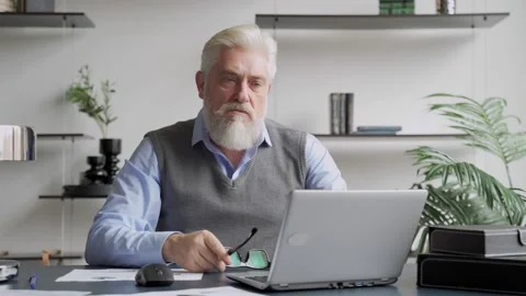 Tired elderly man sit at desk take off glasses rest from laptop work blink rubs Stock Footage 142749963
