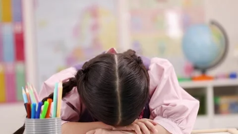 Tired Elementary School Girl Falls Asleep at Desk Stock Footage 321443936