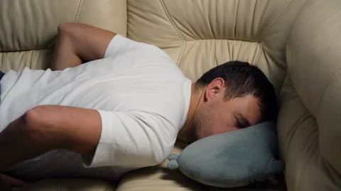 Tired exhausted millennial man falling down on sofa at home after hard working Stock Footage 169370256