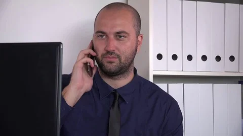 Tired exhausted young business worker yawning yawn inside office phone talking Stock Footage
