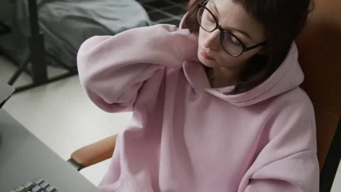 Tired Female Programmer Massaging Neck while Writing Computer Code Stock-Footage 335937004