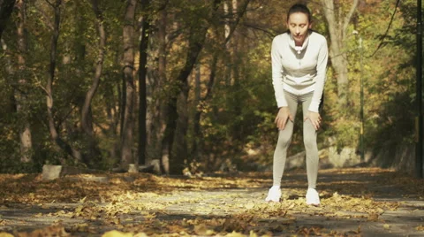 Tired female runner taking a break. Sporty women resting on running. Stock Footage 56918302