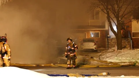Tired firefighter at house fire Stock Footage 125418224