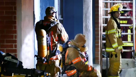 Tired firemen at night Stockbeeldmateriaal 116710765