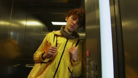 Tired food deliveryman in the elevator Stock Footage 236903313