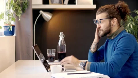 Tired freelancer using laptop. Stock Footage 141377663