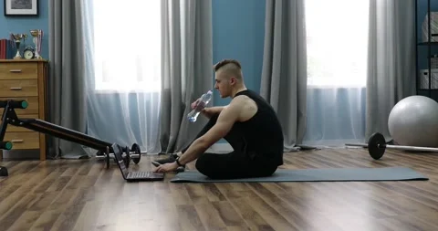 Tired guy drinking water, taking break in workout at home. Sport and hydratio Stock Footage 152833585