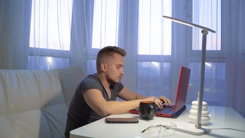 Tired guy is working on a laptop Vidéo 130001533