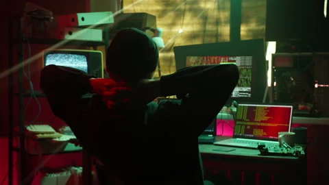 Tired hacker typing on keyboard back view, breaking password on laptop and Stock Footage 159510039