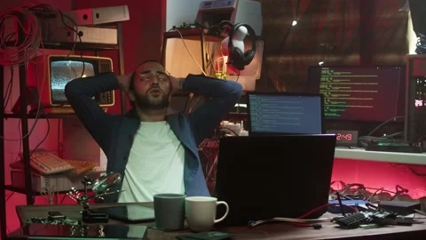 Tired hacker using laptop. Young Spanish man developing program in dark room Stock-Footage 164414366