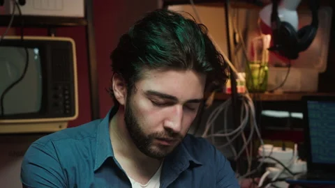 Tired hacker using laptop. Young Spanish man developing program at night Stock Footage 166321226