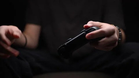 Tired hands holding game controller, symbol of strain and sedentary lifestyle. Vídeo Stock 319139416