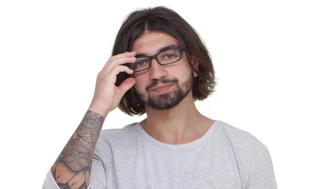 Tired hipster guy taking off glasses isolated over white background in Stock Footage