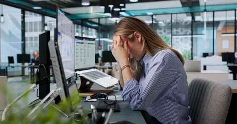 Tired HR Manager Struggles With Payroll Software On Laptop Today. Stock Photos