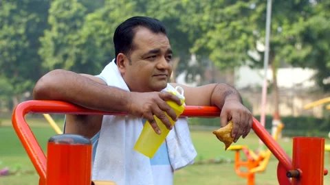 An Indian obese man eating fried samosa ... | Stock Video | Pond5