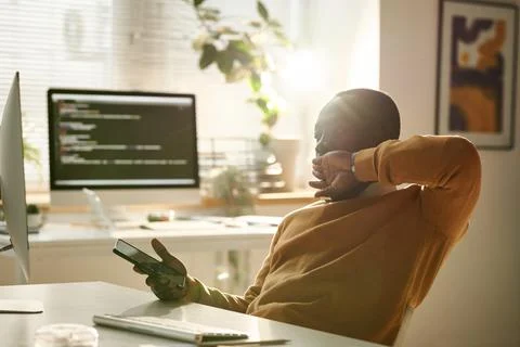 Tired IT developer working on computer Foto stock