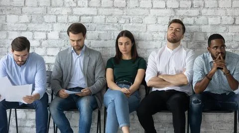 Tired job candidates waiting for interview far too long Stock Photos