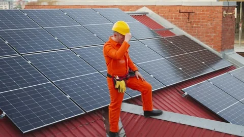 Tired male engineer resting during solar panel installation Stock Footage 343895018