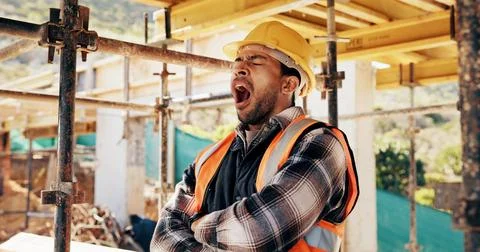 Tired, man and construction worker with yawn on site for burnout, overtime or Stock Photos