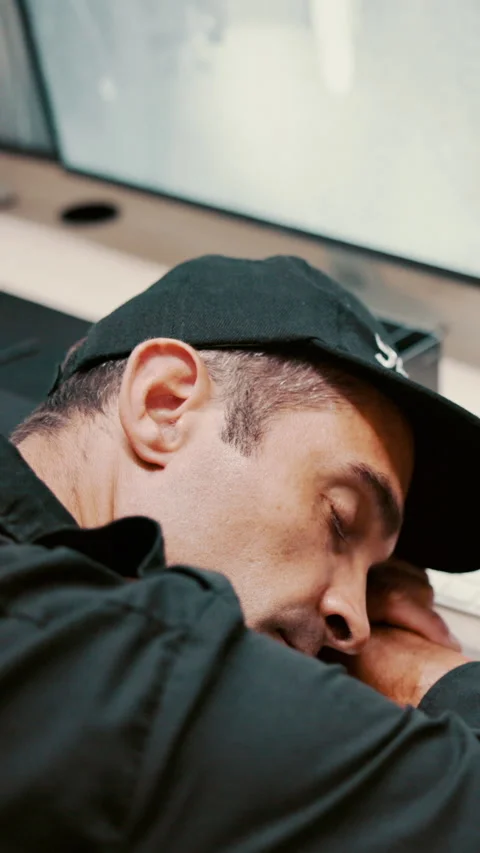 Tired, man and sleeping with security guard on desk for fatigue, burnout or Stock Footage 335296407