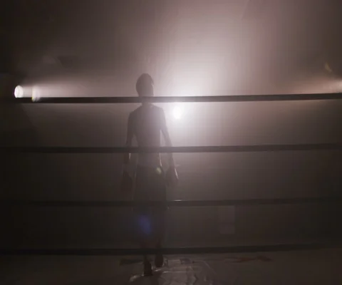 Tired man in boxing ring leaning on ropes with spotlights, Japan Video stock 147052956