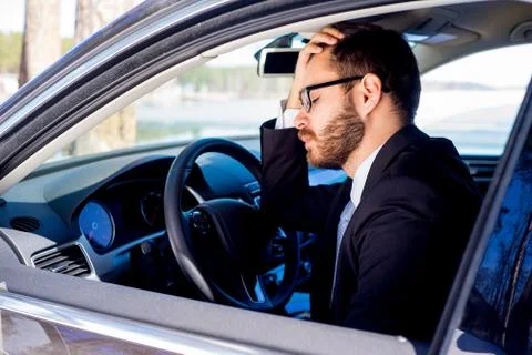 Tired man in a car Stock Photos