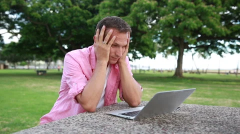 Tired Man With Computer Having Headache At The Park Stock Footage 55620217