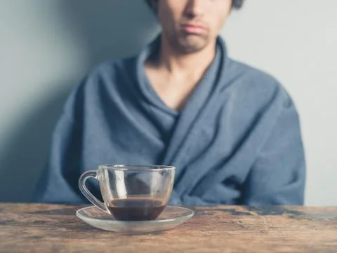 Tired man drinking coffee Stock Photos