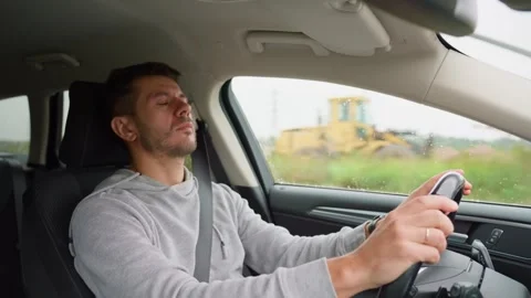 Tired man falling asleep while driving car Stock Footage 289510647