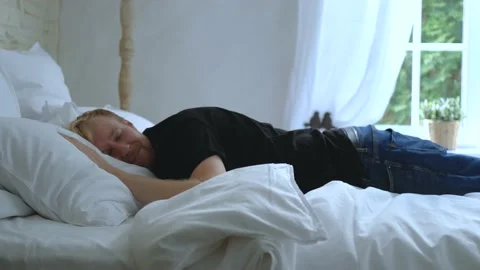 Tired man fell on the bed Stock Footage 200823707