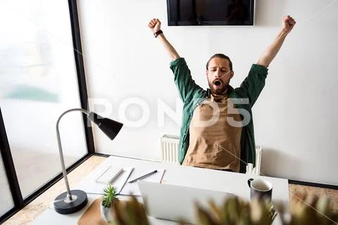 Tired man is gaping in office Stock Photos