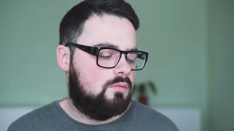 Tired man in glasses looking to camera in 4K Vídeo Stock 72634399