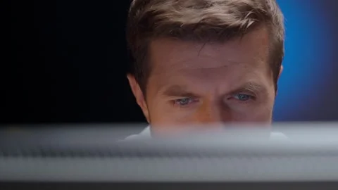 Tired man looking at computer screen at night Stock Footage 316550551