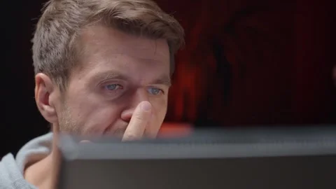 Tired man looking at computer screen at night Stock Footage 316550662