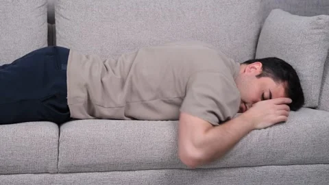 Tired man lying on sofa Video stock 269709783