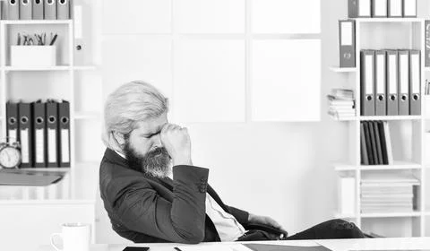 Tired man at office table with folder. business intelligence analyst. enterprise 스톡 사진