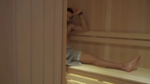 Tired man resting and sweating in the spa sauna Stock Footage 127649045