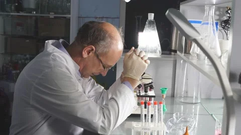 Tired man scientist,crashing, with failed experiments and working long hours. Stock Footage 145221067