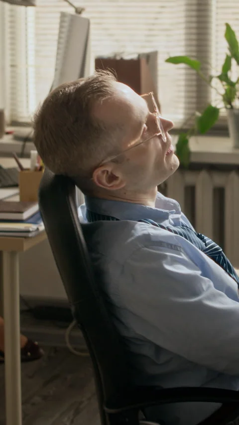 Tired Man Sitting in Computer Chair in Office during Summer Day Stock-Footage 335459607