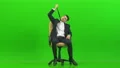 The tired man sitting on the office chair on the green background 4k or 4k+ Resolution