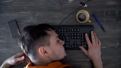Tired man sleeping on the keyboard, working in the morning in the office Stock Footage 124360697