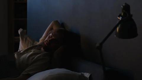 Tired Man Sleeping with Laptop in Bed after Working Late Stock Footage 345514776