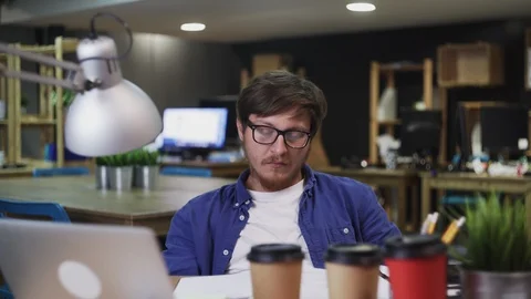 Tired man sleeping while working in the office Stock Footage 121778040