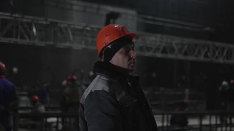 Tired man stands motionless as workshop blurs behind Video stock 314649330