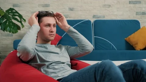 Tired man suffering from headache, massaging temples, exhausted. Stock Footage 147138580