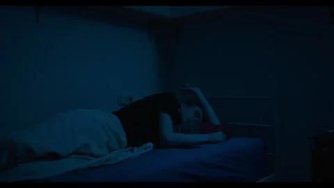 Tired man suffering from insomnia using laptop in bed at night Stock Footage 341711319