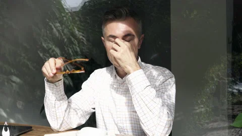 Tired man working and taking off glasses. Video stock 141746672
