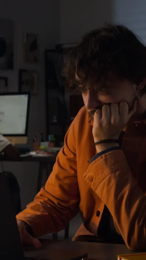 Tired Man Working Late on Laptop in Dark Office Feeling Stressed Stock Footage 338418922