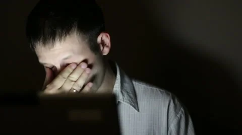 The tired man works at the computer late at night Stock Footage 66252322